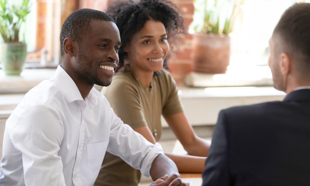 A couple talking to a financial planner. 